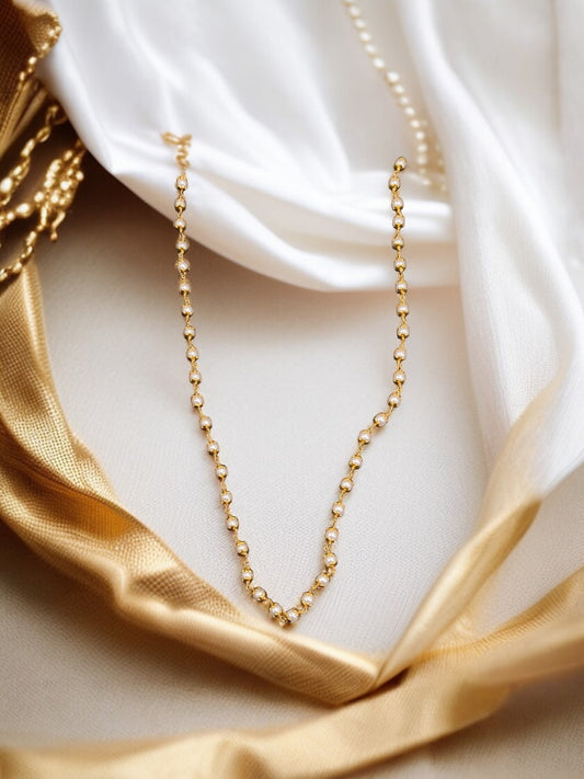 gold-plated chain with white stone beads.