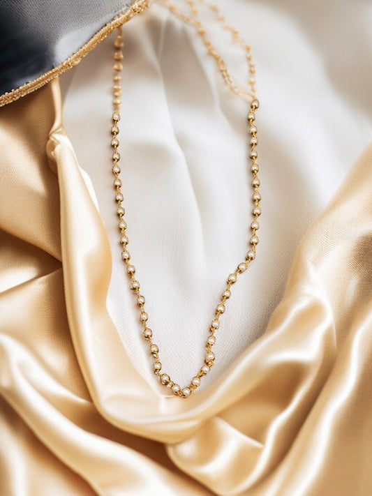 gold-plated chain with white stone beads.